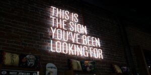 Neon lights saying "This is the sign you're looking for." digital signage content