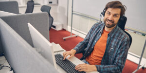 Contact Center employee smiling at desk