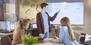 Boy Shows His Presentation on Interactive Whiteboard Project, IT device management, touchscreen