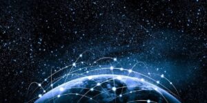 The earth from space with beams of light interconnected to depict a global network.