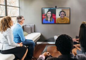 People in a conference room using HP & Poly devices certified for Microsoft Teams.